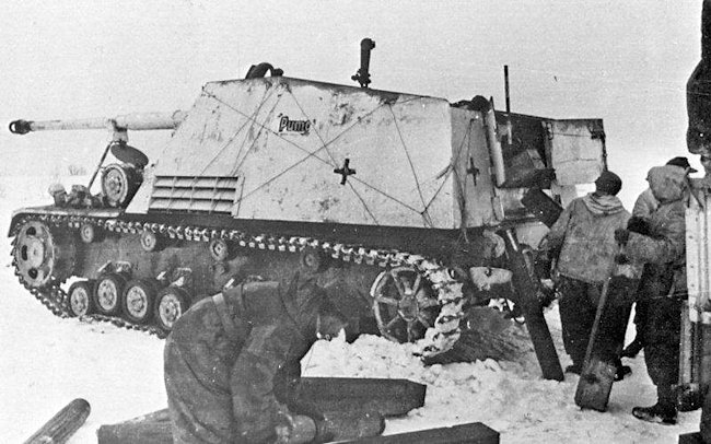 Nashorn 88mm self-propelled gun in winter whitewash livery on the Eastern Front. The crew are loading ammunition.