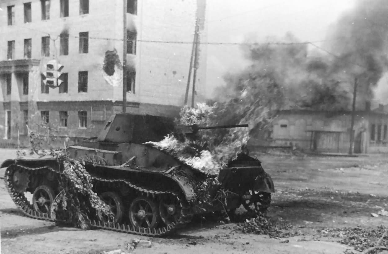 A T-60 burns in a street. The armor was simply too poor.
