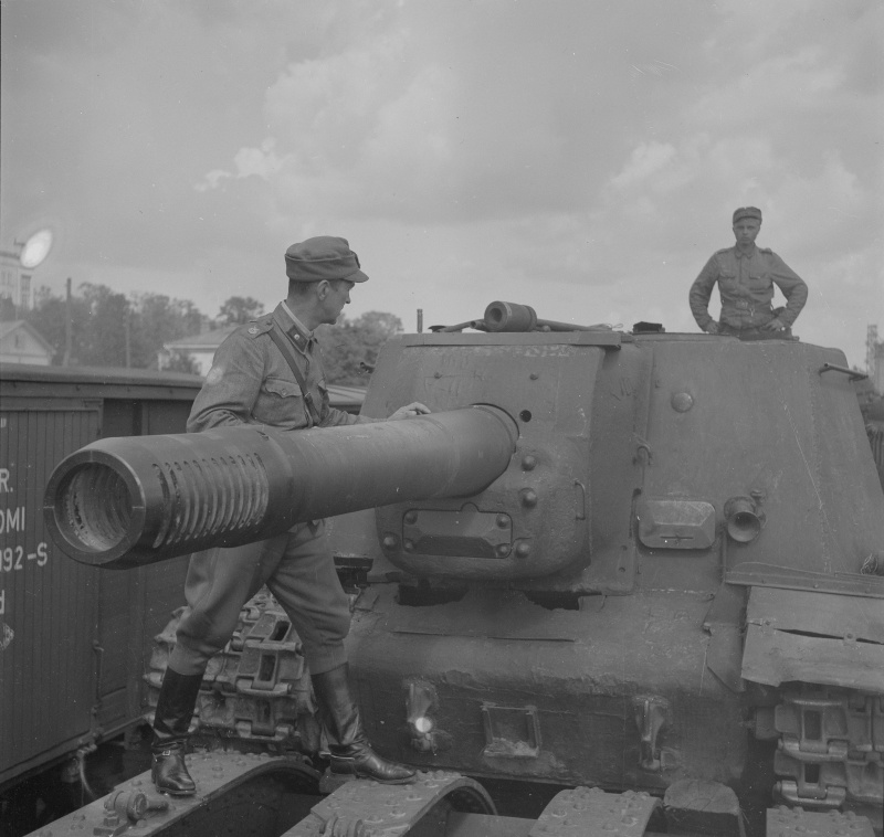 Finnish troops prepare a captured ISU-152 for rail transport.