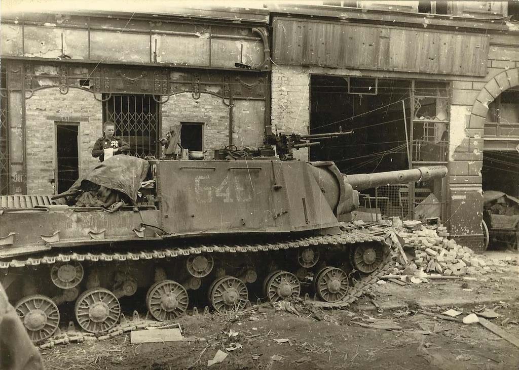 A knocked out ISU-152 in Berlin. The main gun has been shot by a Panzerfaust, and it appears as though the hull was hit by numerous rounds, too.